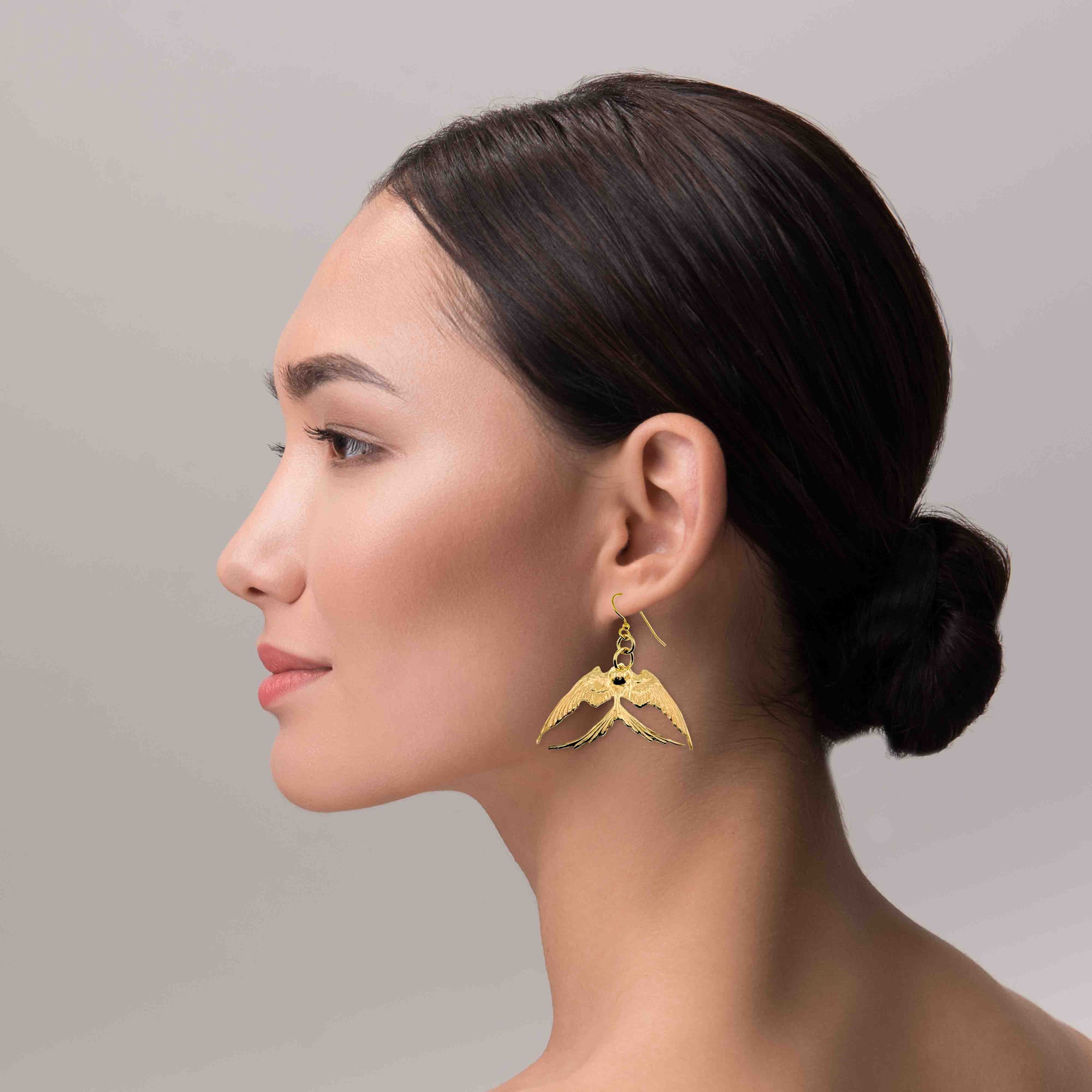 A Stunning Woman Wearing Medium Nu Gold Brass Swallow Earrings 