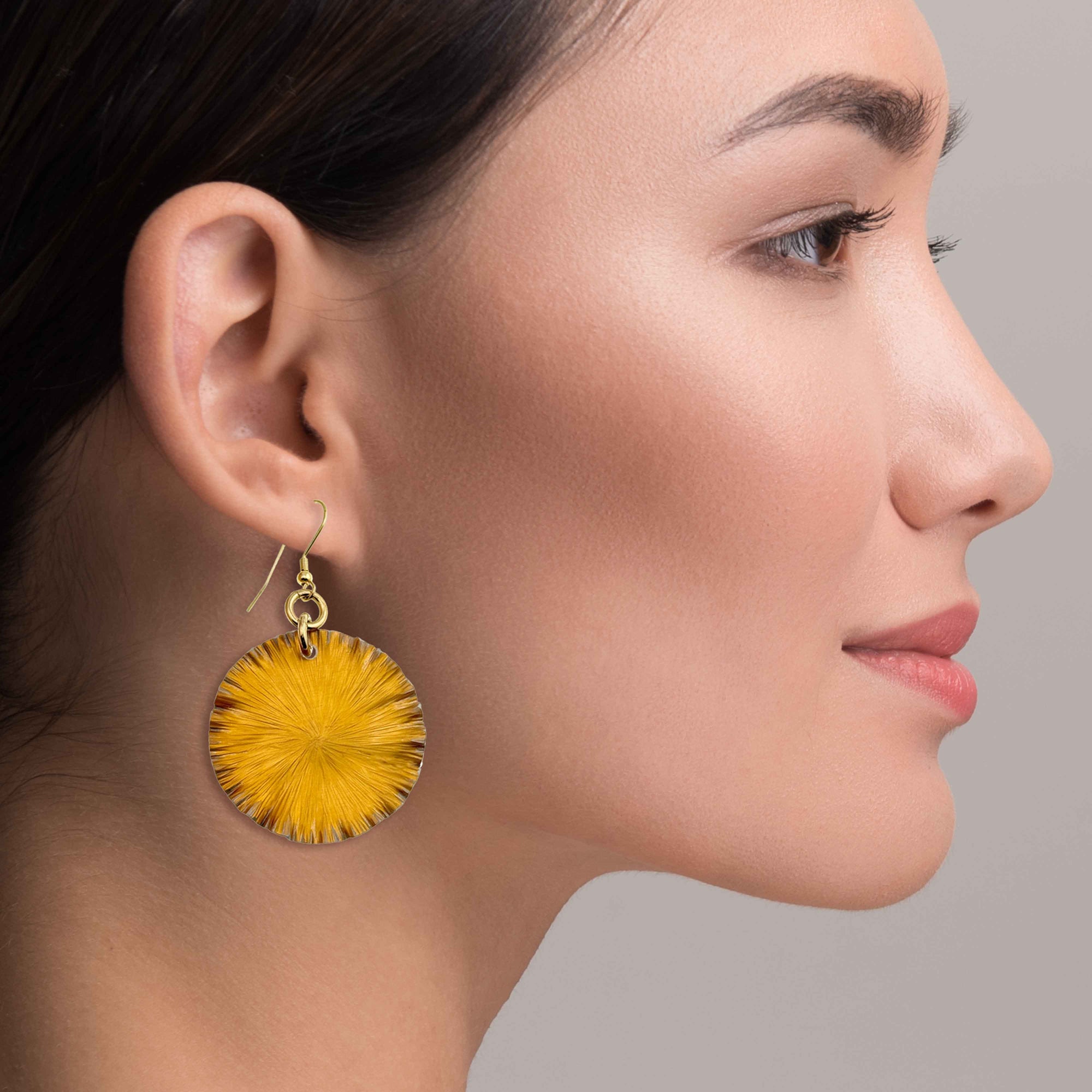 An Elegant Woman Wearing Orange Lily Pad Earrings