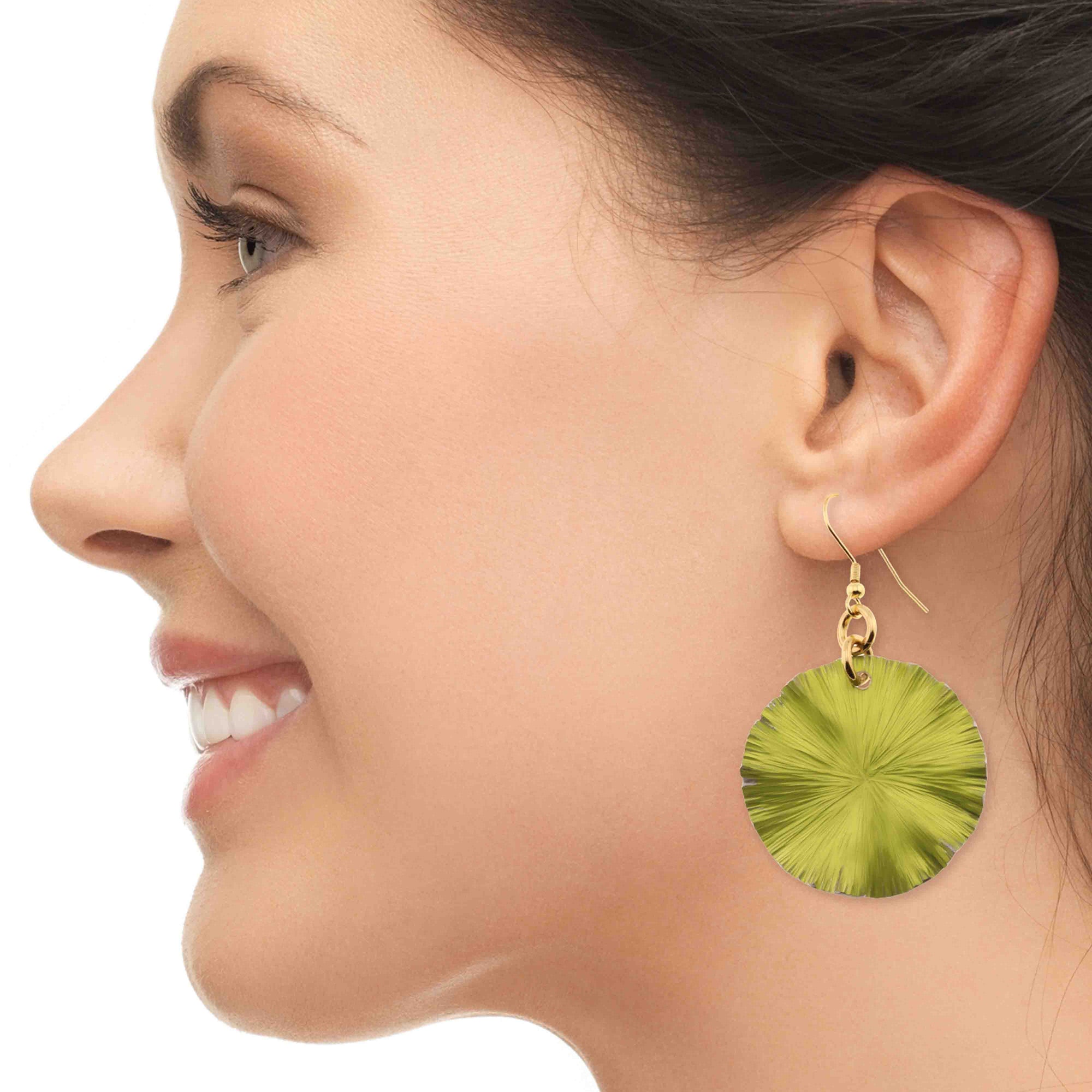 A Smiling Woman Wearing Medium Sour Candy Apple Anodized Aluminum Lily Pad Earrings
