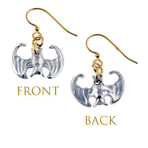 3 of 7: Bat-shaped earrings with gold and silver finishes on a white background.