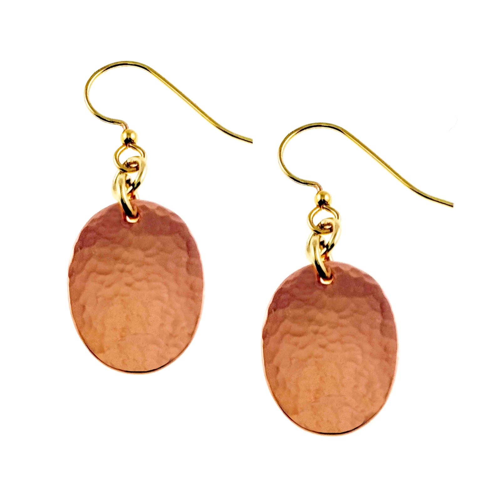 Pair of Mini Hammered Copper Oval Disc Earrings displayed on a clean white background. Each earring has a small warm copper oval with a polished hand hammered surface, attached to a brass French ear wire with connecting rings. The simple drop design shows the natural reddish copper color and reflective texture.