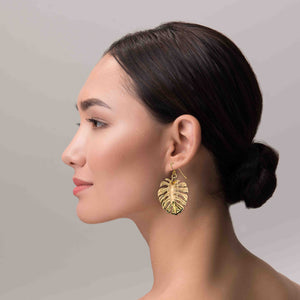 2 of 6: An Elegant Woman Wearing Monstera Nu Gold Brass Leaf Earrings
