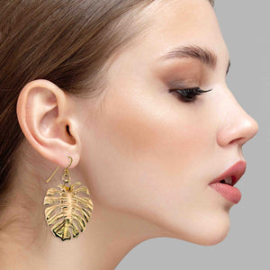 4 of 6: A Chic Woman Wearing Monstera Nu Gold Brass Leaf Earrings
