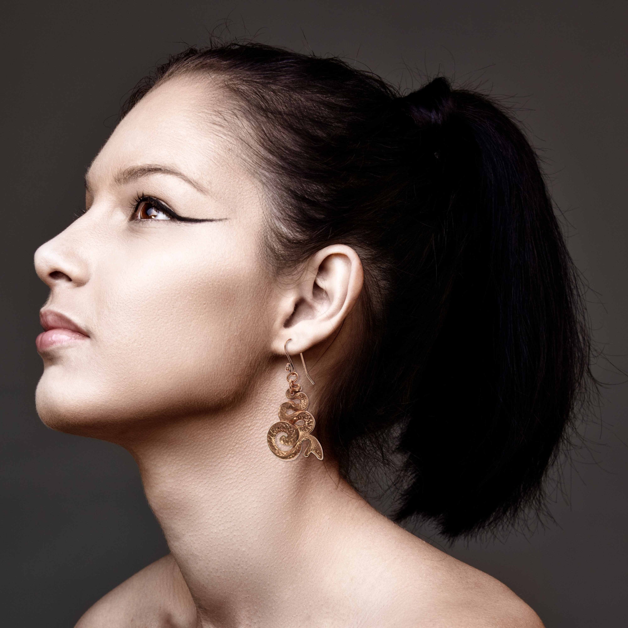 Stunning Woman Wearing Mystic Snake Copper Drop Earrings