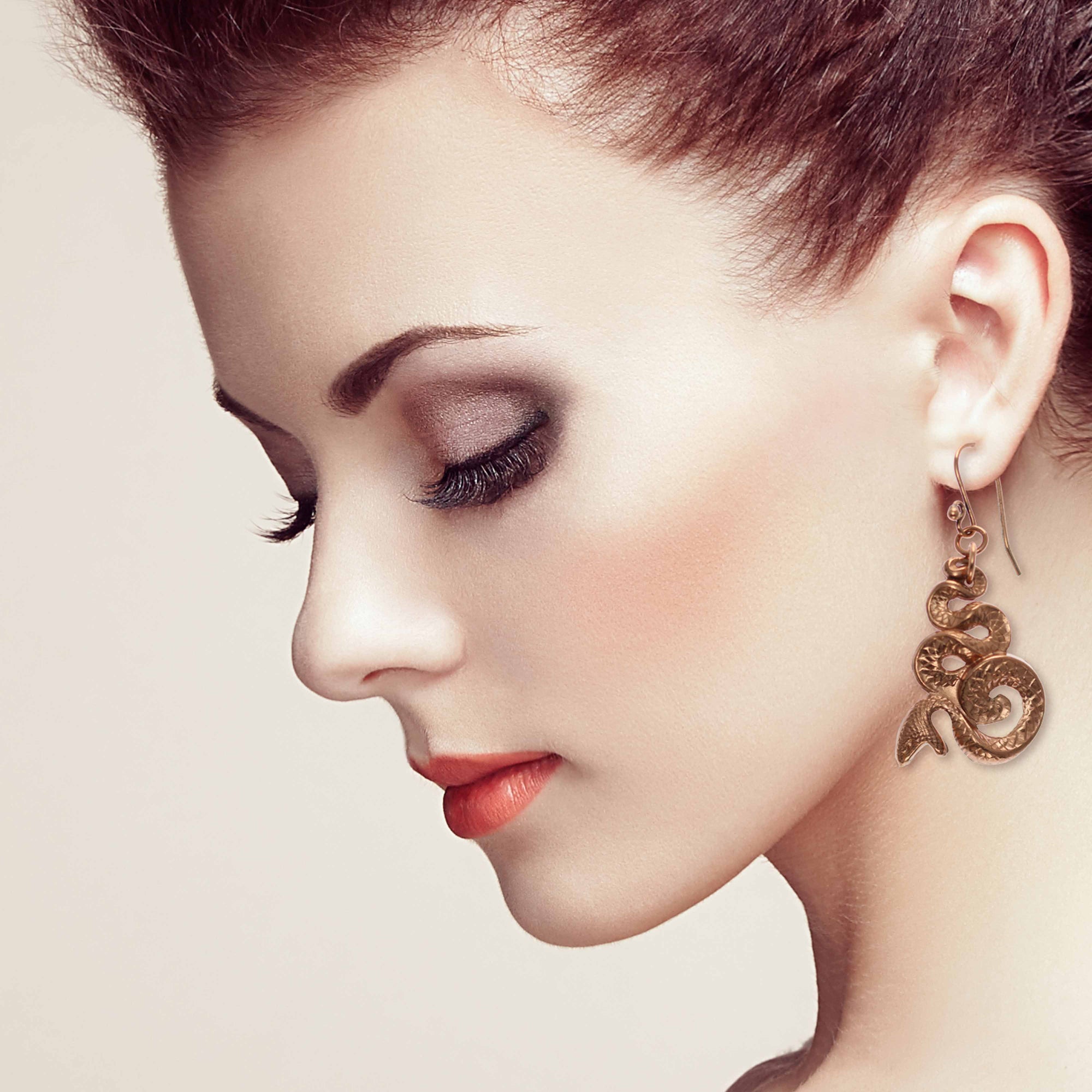Elegant Woman Wearing Mystic Snake Copper Drop Earrings
