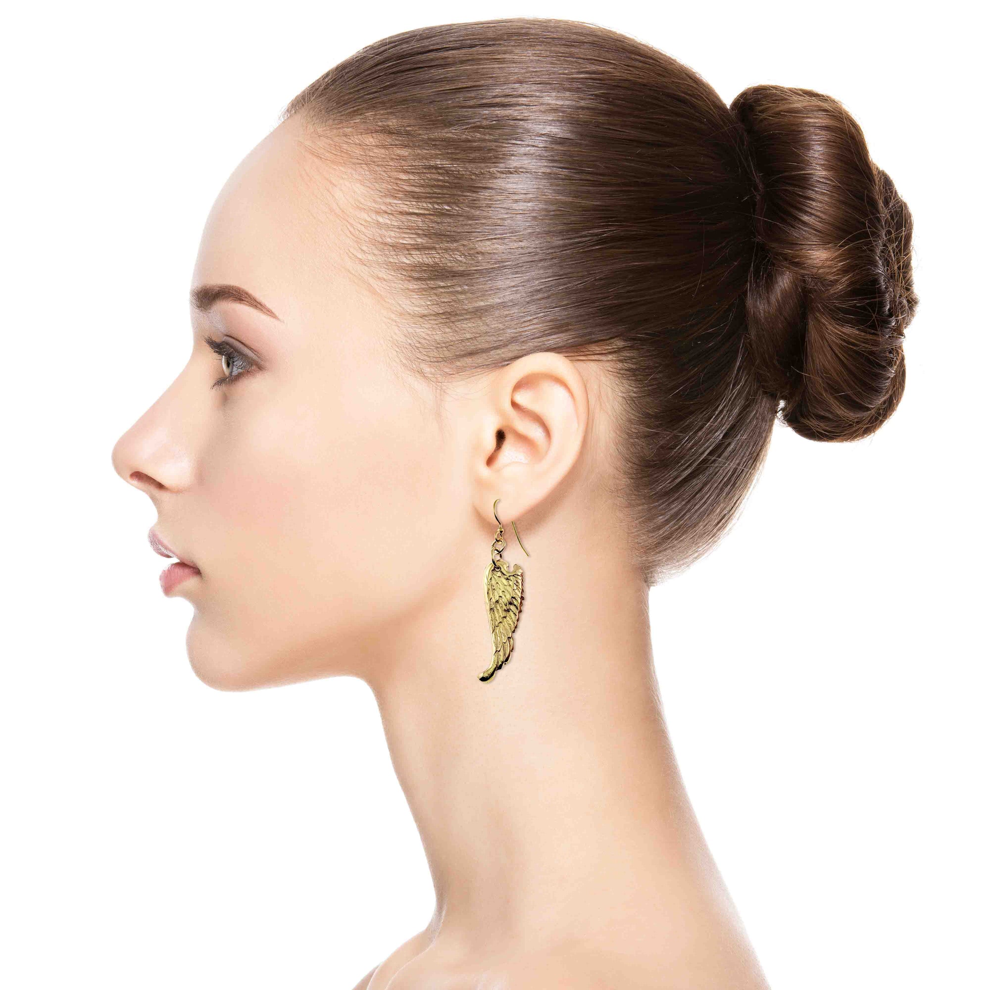Woman wearing Nu Gold Brass Guardian Angel Wing Drop Earrings  with a plain background