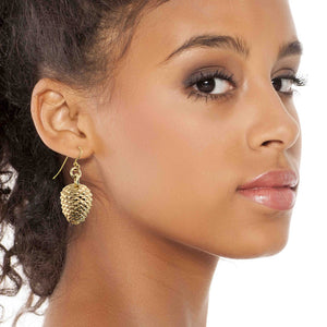 2 of 7: Close-up of a woman wearing Nu Gold Brass Pinecone Dangle Earrings on a white background