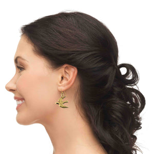 2 of 7: Woman wearing Nu Gold Brass Flying Swallow Earrings with a side view of her hair and face.
