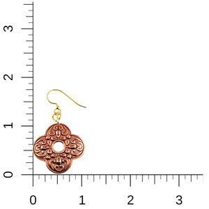 5 of 7: Product image of a single ornate clover-shaped copper drop earring placed next to a measurement ruler for scale. The earring features detailed scrollwork with a small center cutout and hangs from a gold tone brass French ear wire. The ruler shows the earring measures approximately 1 3/4 inches long and 1 inch wide.