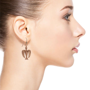 2 of 7: Glamorous Woman Wearing Peace Dove Copper Drop Earrings