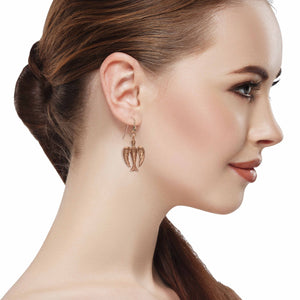 6 of 7: Stunning Redhead Woman Wearing Peace Dove Copper Drop Earrings