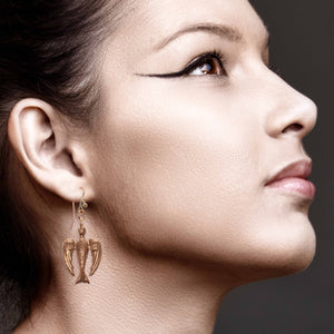 4 of 7: Elegant Woman Wearing Peace Dove Copper Drop Earrings