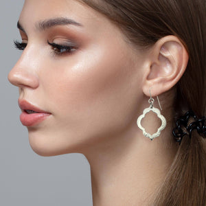4 of 9: A Woman Wearing Pierced Hammered Quatrefoil Aluminum Earrings