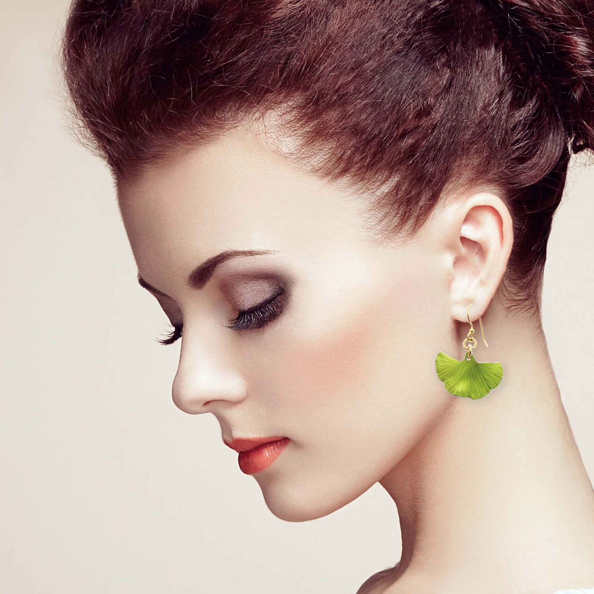 Elegant Woman with Red Hair Wearing Small Ginkgo Leaf Anodized Aluminum Sour Candy Apple Earrings