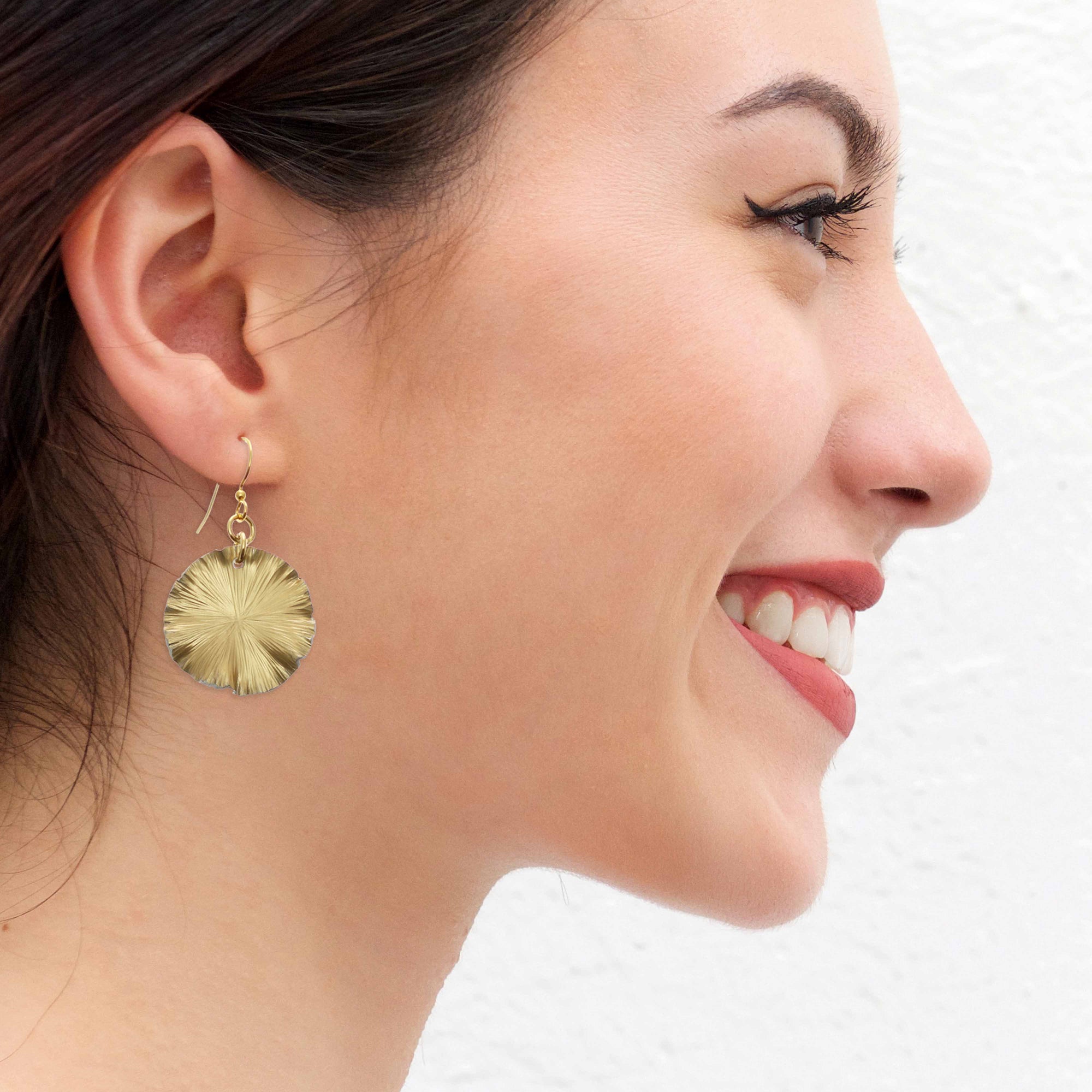 Smiling Women Wearing Small Gold Anodized Lily Pad Leaf Drop Earrings