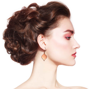 6 of 7: A Chic Woman with Red Hair Wearing Small Hammered Copper Marrakesh Drop Earrings