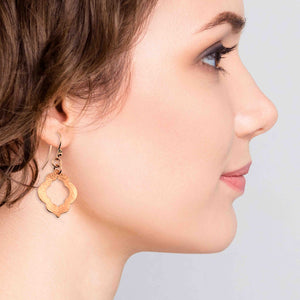 6 of 7: A Chic Woman Wearing Small Hammered Copper Pierced Quatrefoil Dangle Earrings