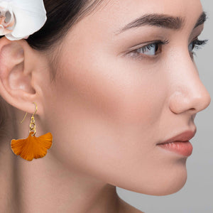 6 of 7: A Stylish Woman Wearing Small Orange Anodized Aluminum Ginkgo Leaf Earrings