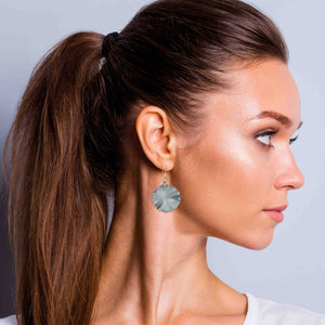 6 of 7: A Chic Woman Wearing Small Lily Pad Anodized Aluminum Pewter Gray Leaf Earrings