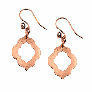 1 of 7: A Pair of Small Hammered Copper Pierced Quatrefoil Dangle Earrings on a White Background