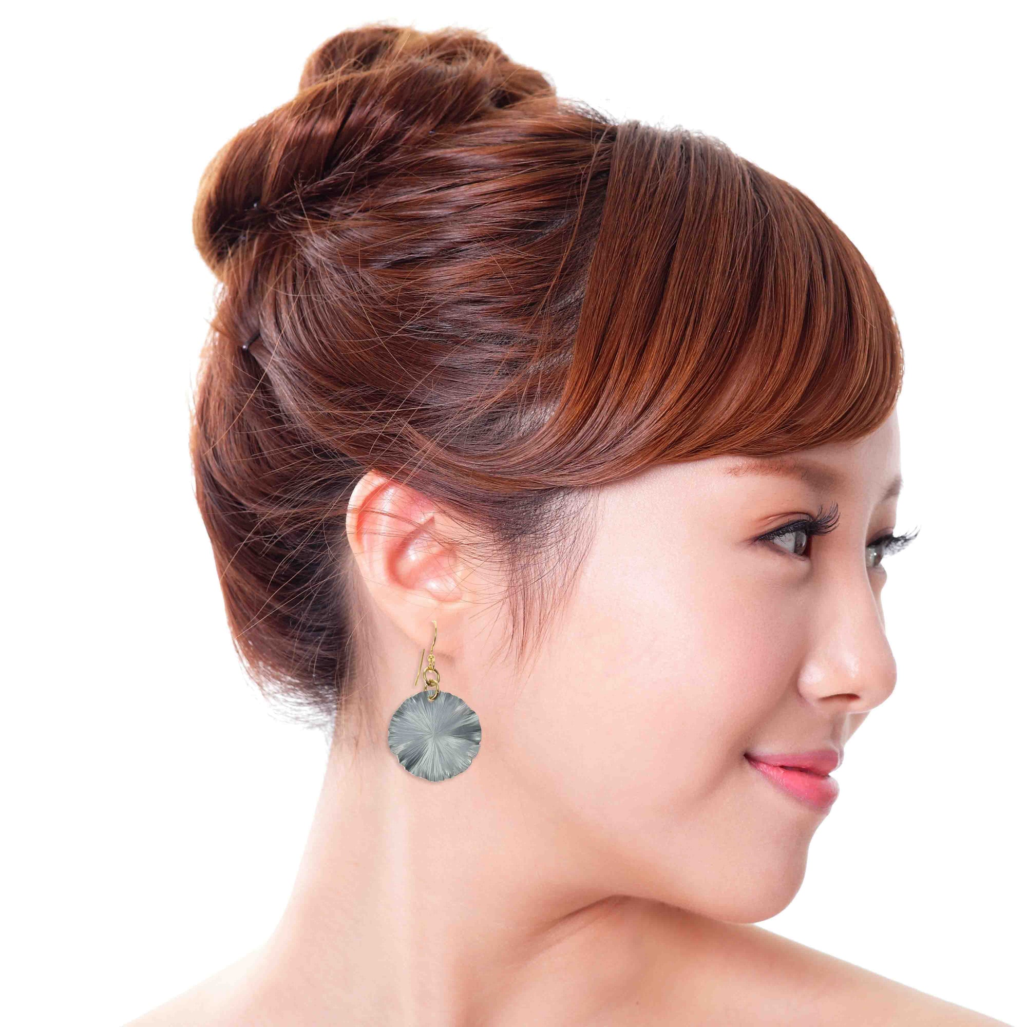 A Fashionable Woman Wearing a Small Pewter Gray Anodized Lily Pad Leaf Drop Earrings