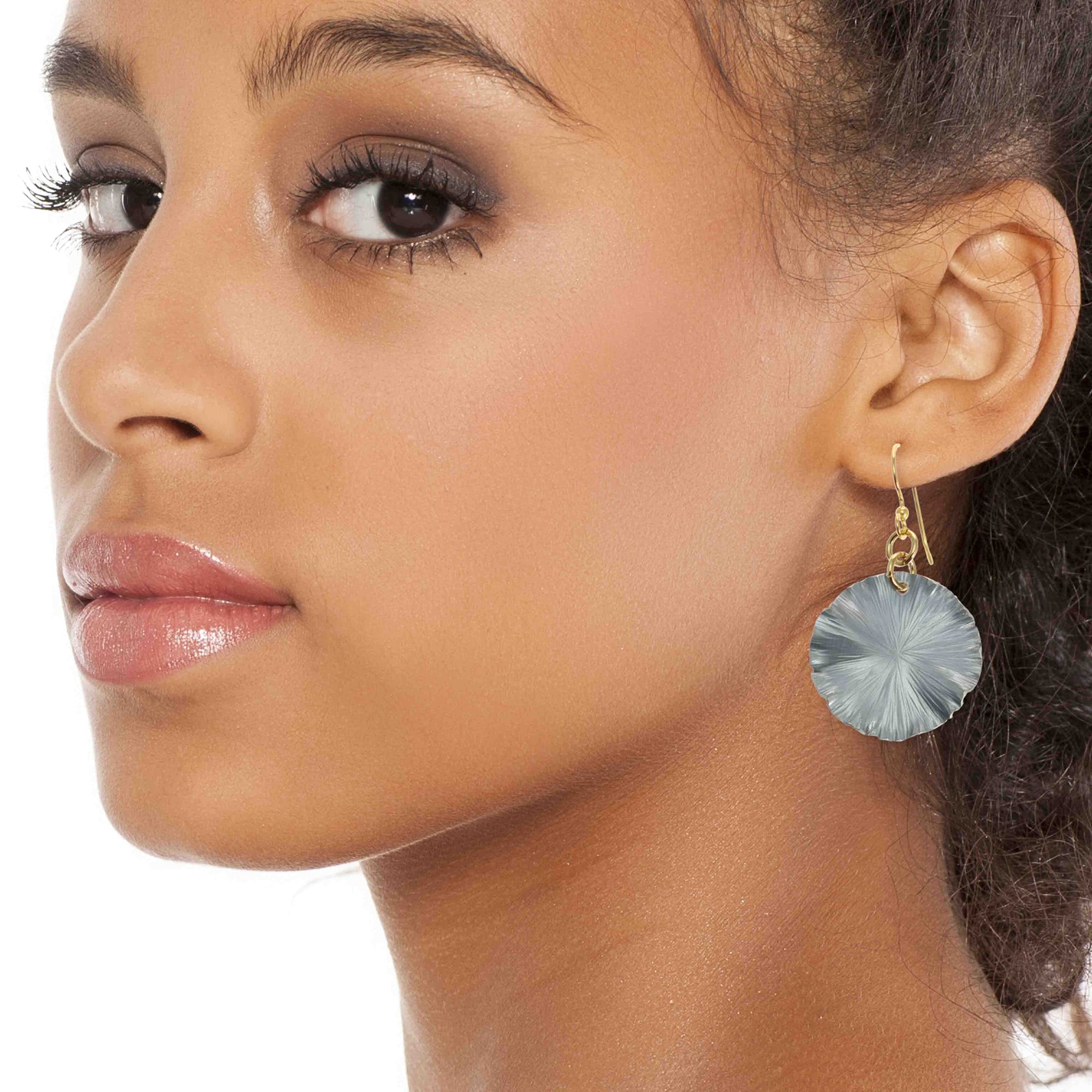 A Chic Woman Wearing Small Pewter Gray Anodized Lily Pad Leaf Drop Earrings