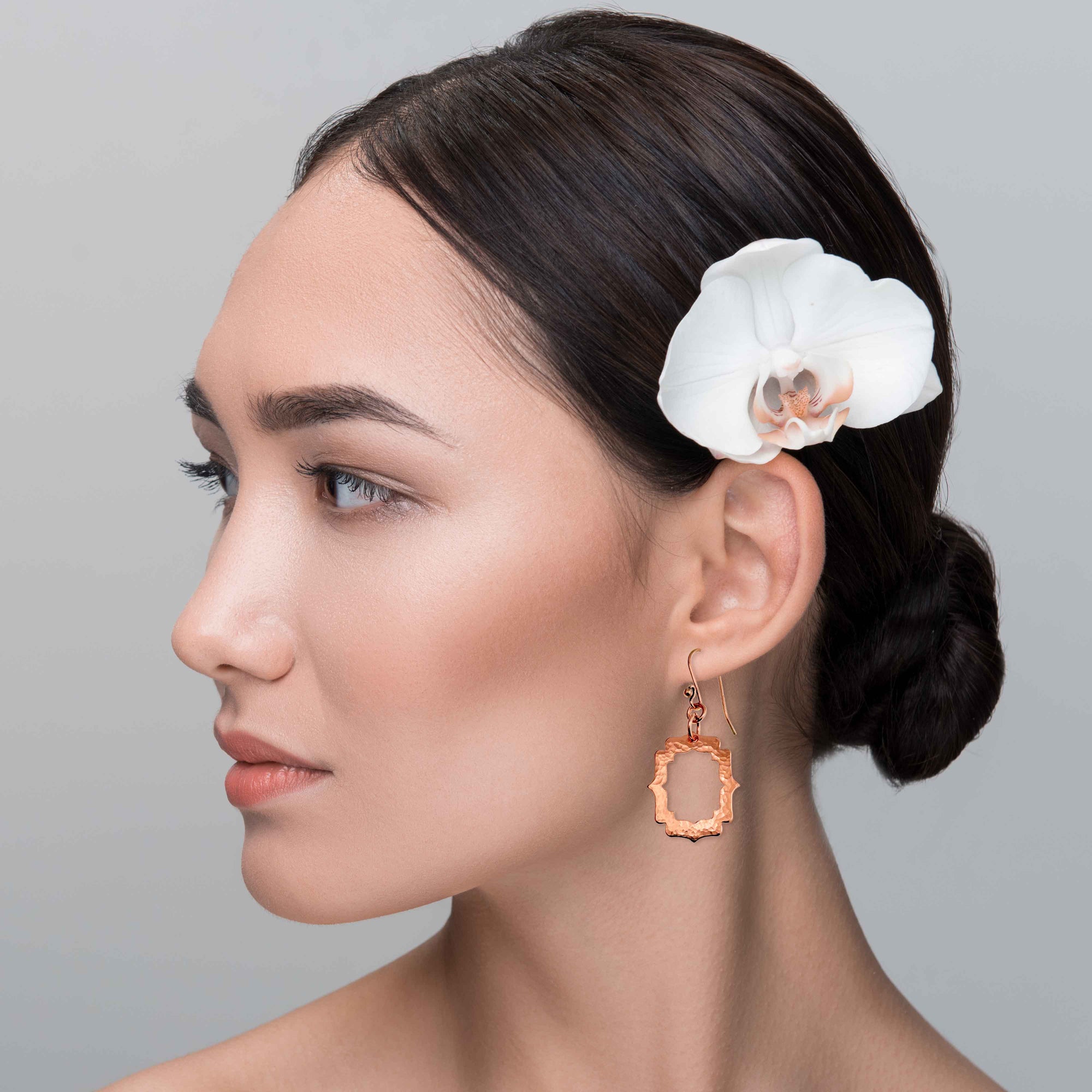An Elegant Woman Wearing Small Pierced Hammered Copper Arabesque Shield Earrings