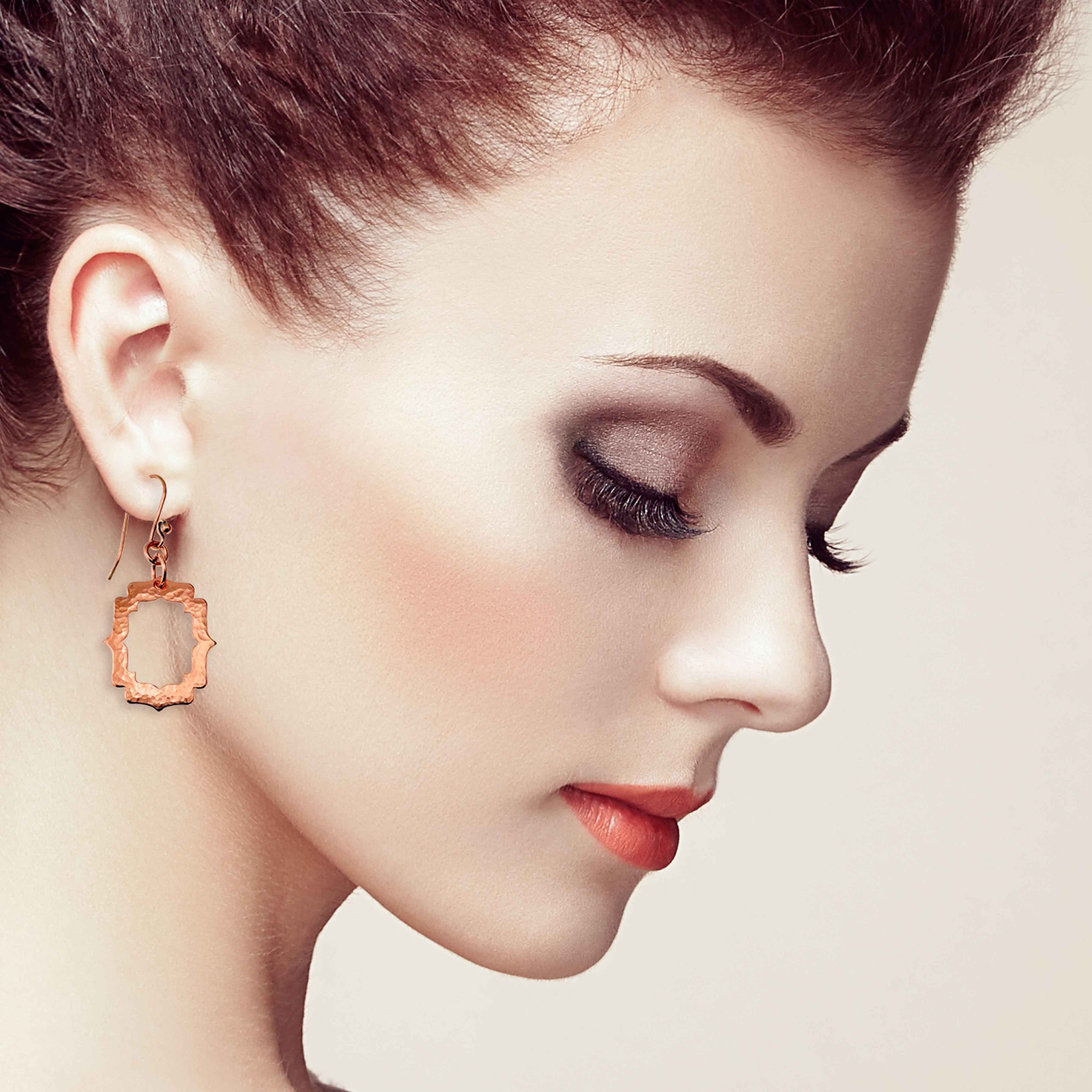 A Stunning Woman Wearing Small Pierced Hammered Copper Arabesque Shield Earrings