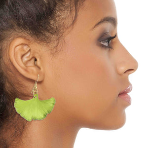 4 of 7: A Fashionable Woman Wearing Medium Sour Candy Apple Anodized Aluminum Ginkgo Leaf Earrings