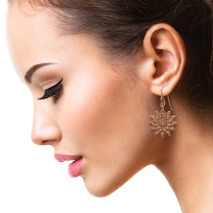 2 of 7: Stunning Woman Wearing Starburst Mandala Copper Earrings 