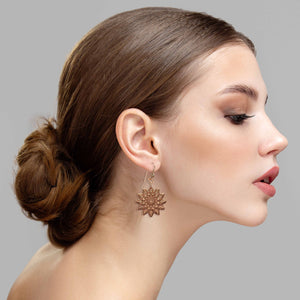 4 of 7: Elegant Woman Wearing Starburst Mandala Copper Earrings 