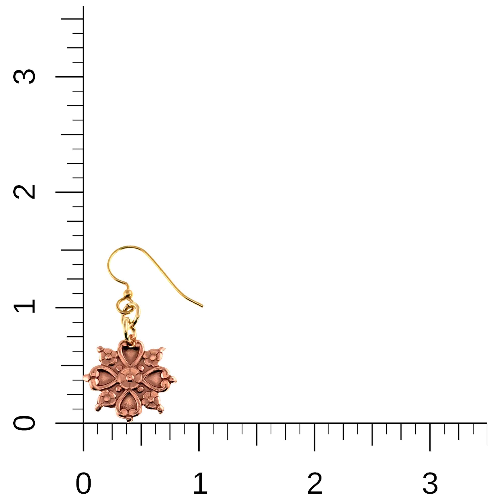 Victorian Copper Snowflake Dangle Earring on a ruler for scale.