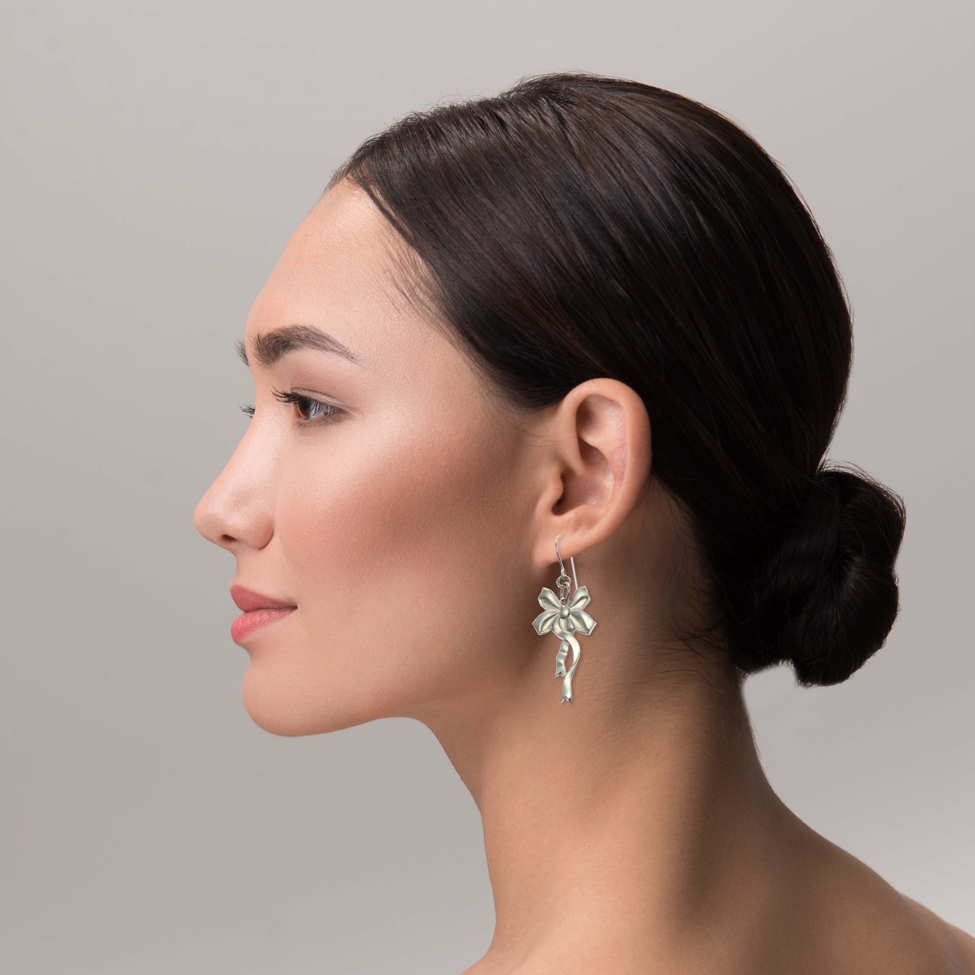 Stunning Woman Wearing Yuletide Ribbon Aluminum Dangle Earrings