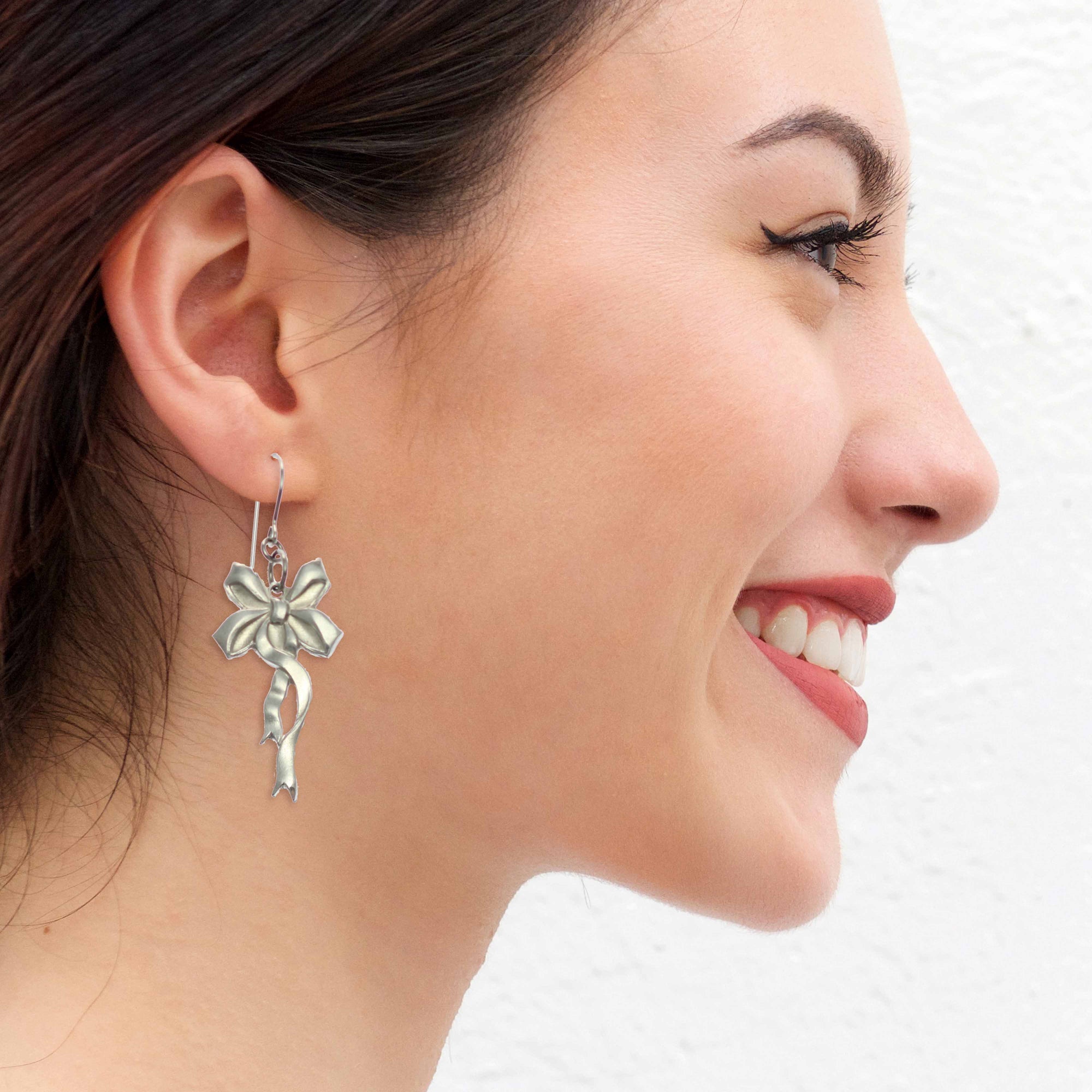 Woman Wearing Yuletide Ribbon Aluminum Dangle Earrings