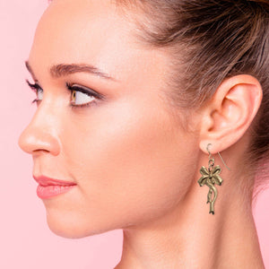 2 of 7: Stylish Woman Wearing Yuletide Ribbon Bronze Dangle Earrings