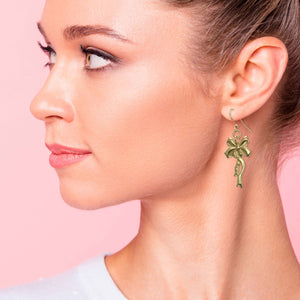 4 of 7: Elegant Woman Wearing Yuletide Ribbon Nu Gold Brass Dangle Earrings