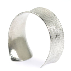 4 of 7: Right View of Anticlastic Tapered Linen Aluminum Bangle