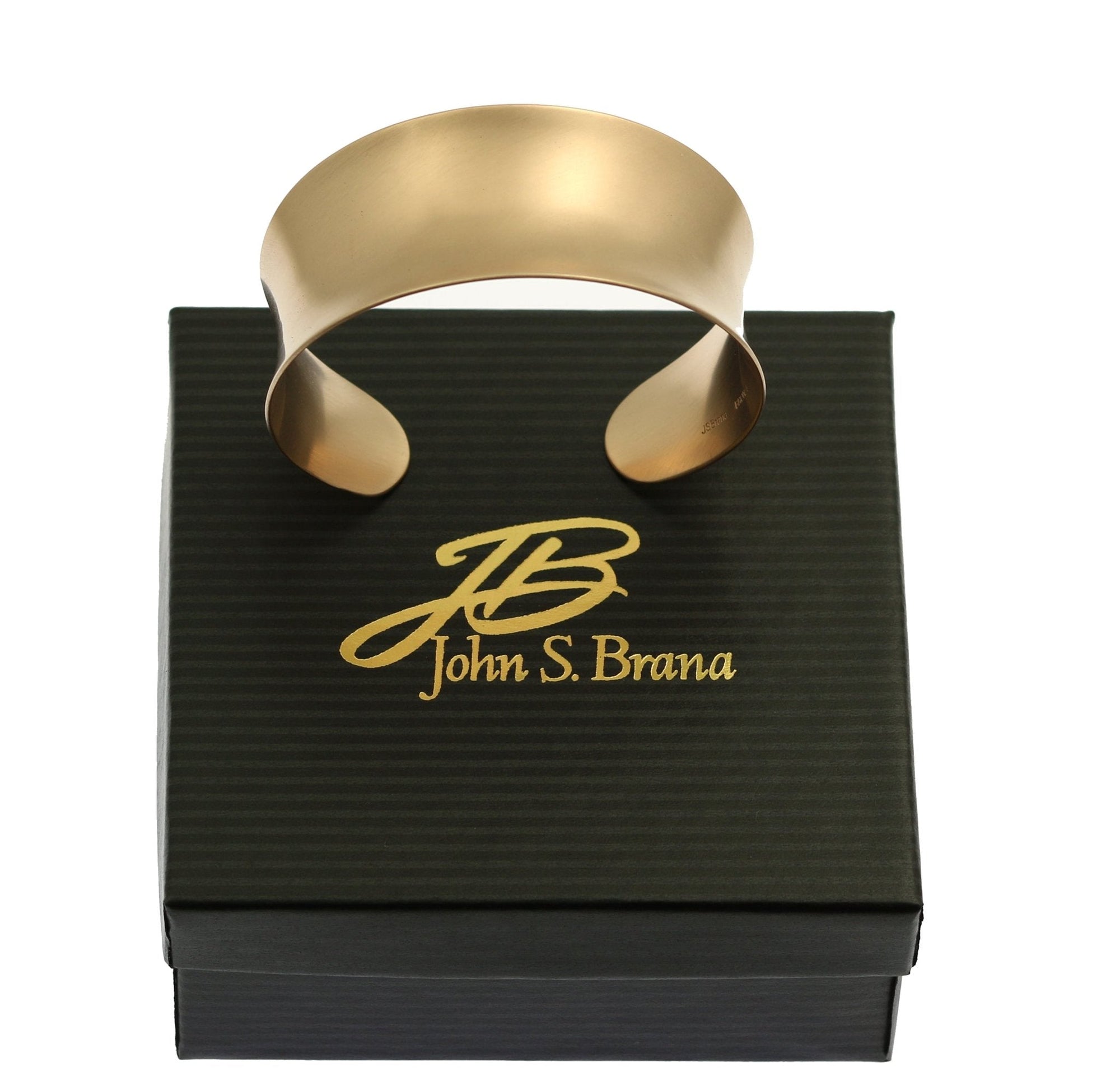 Brushed Bronze Anticlastic Cuff on top of a Black Branded Gift Box