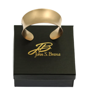 7 of 9: Brushed Bronze Anticlastic Cuff on top of a Black Branded Gift Box