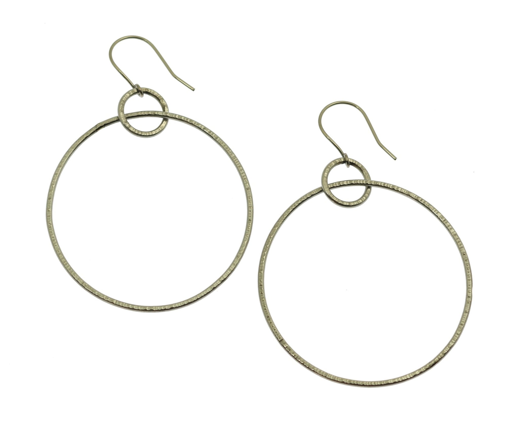 A Pair of Chased Stainless Steel Hoop Earrings on a White Background