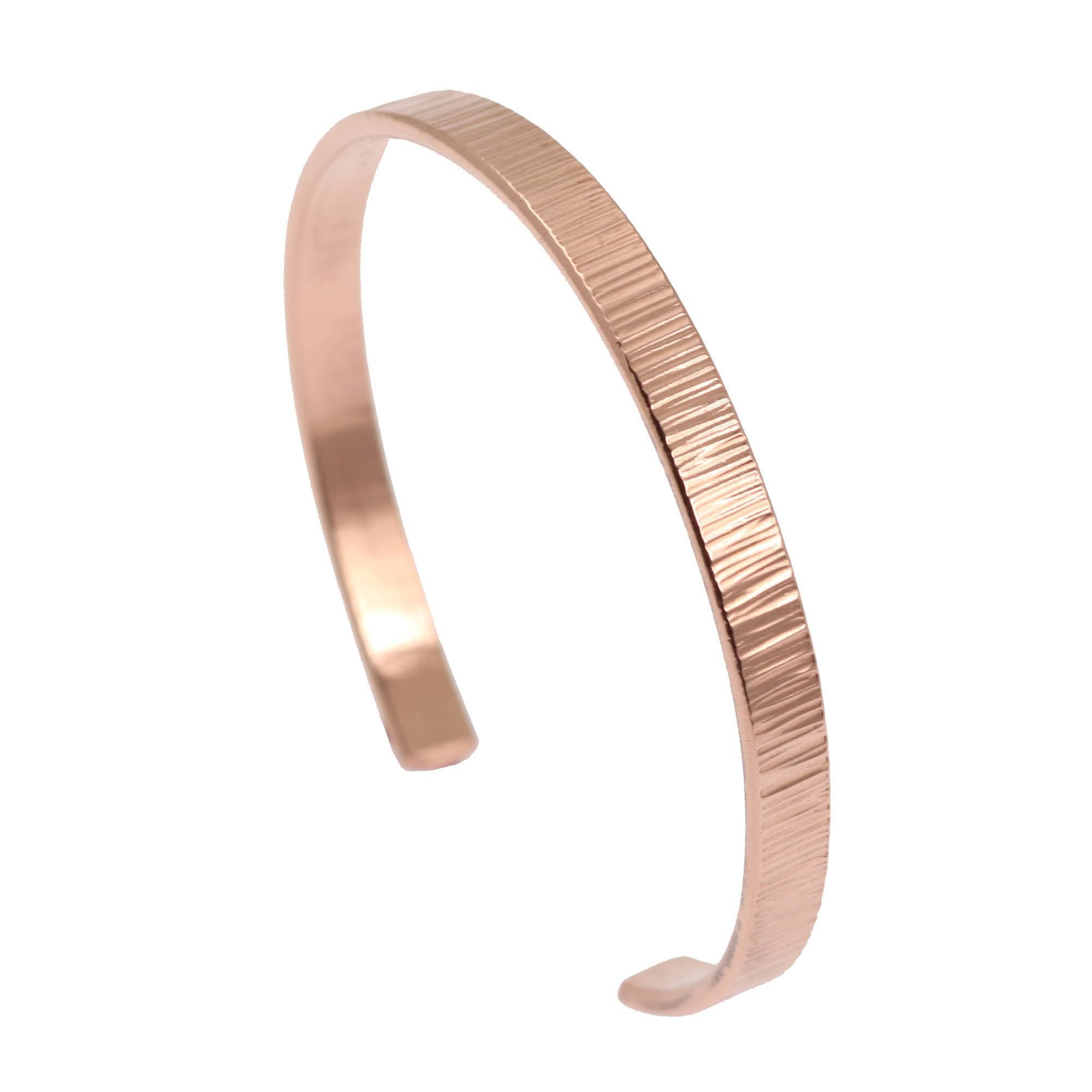 A Men's Thin Chased Copper Cuff Bracelet on a White Background