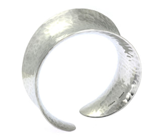 1 of 5: A Hammered Aluminum Anticlastic Bangle on a White Background