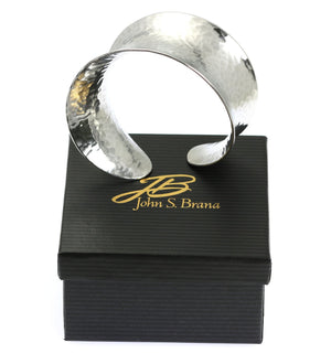 4 of 5: Hammered Aluminum Anticlastic Bangle on top of a Black Gift Box