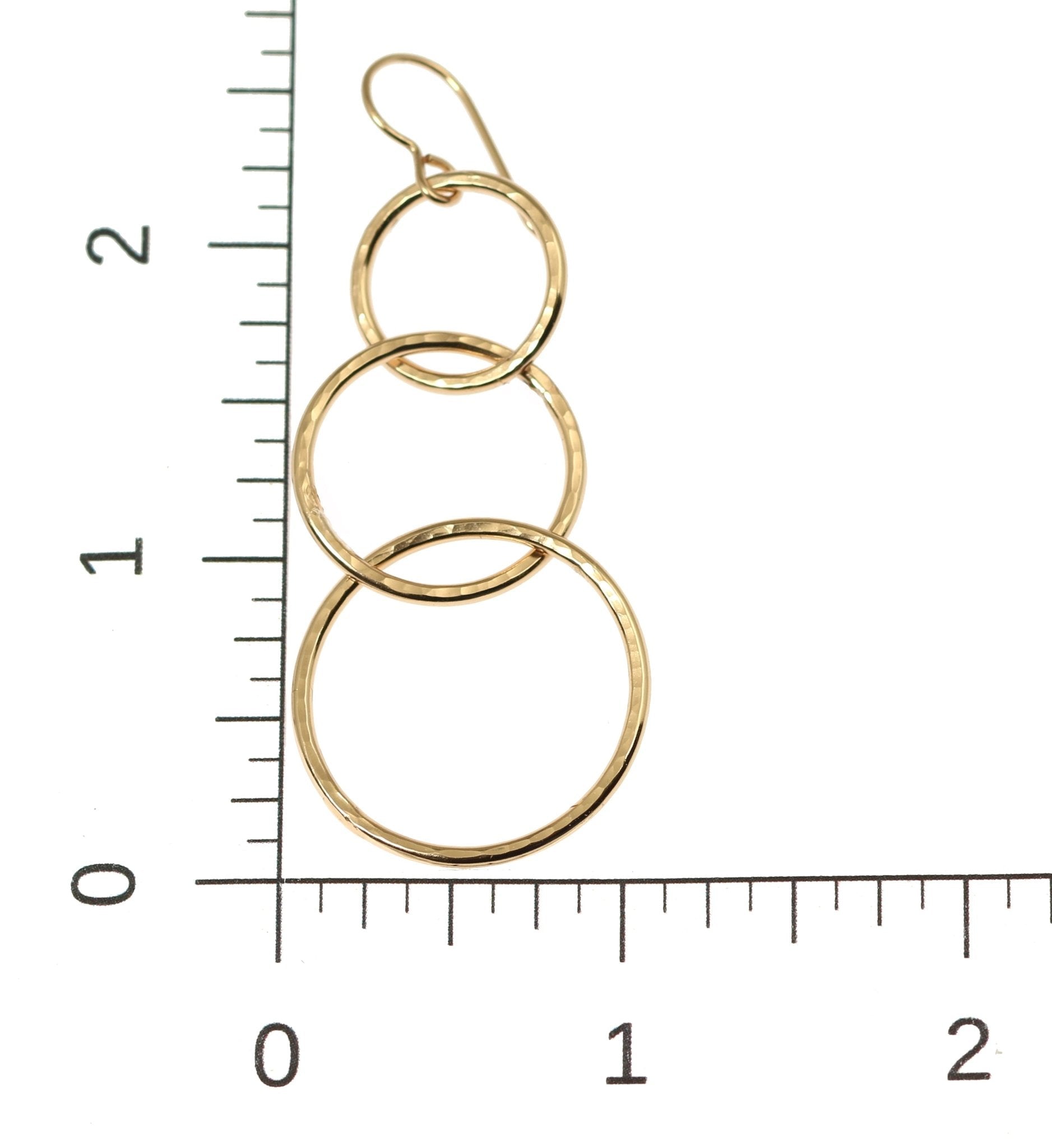 Scale of Hammered Bronze Three Tiered Dangle Earrings on a Ruler for Size Dimensions