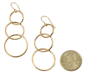 3 of 8: Size of Hammered Bronze Three Tiered Dangle Earrings compared to a US Quarter Coin