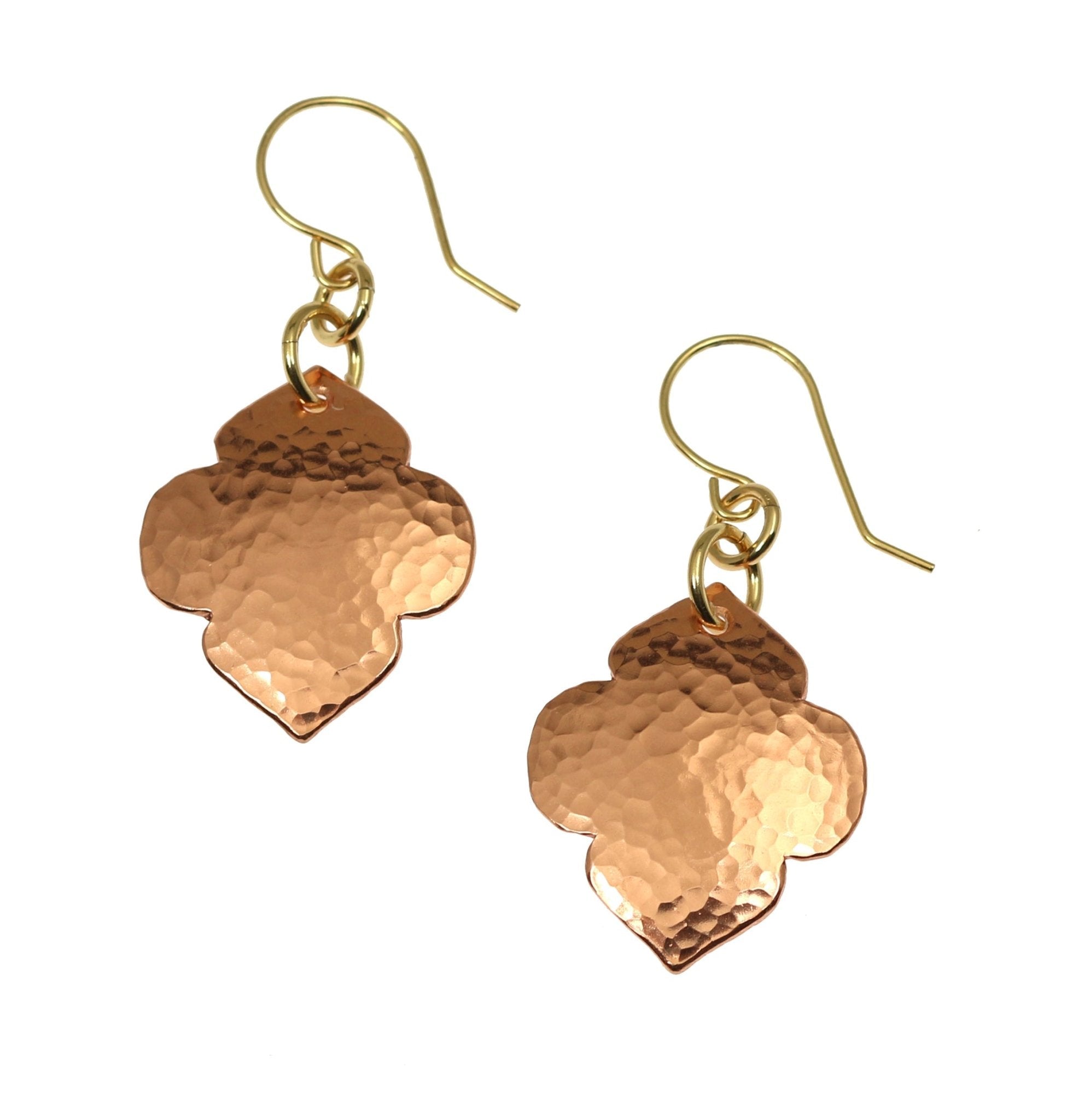 A Pair of Hammered Copper Quatrefoil Dangle Earrings on a White Background