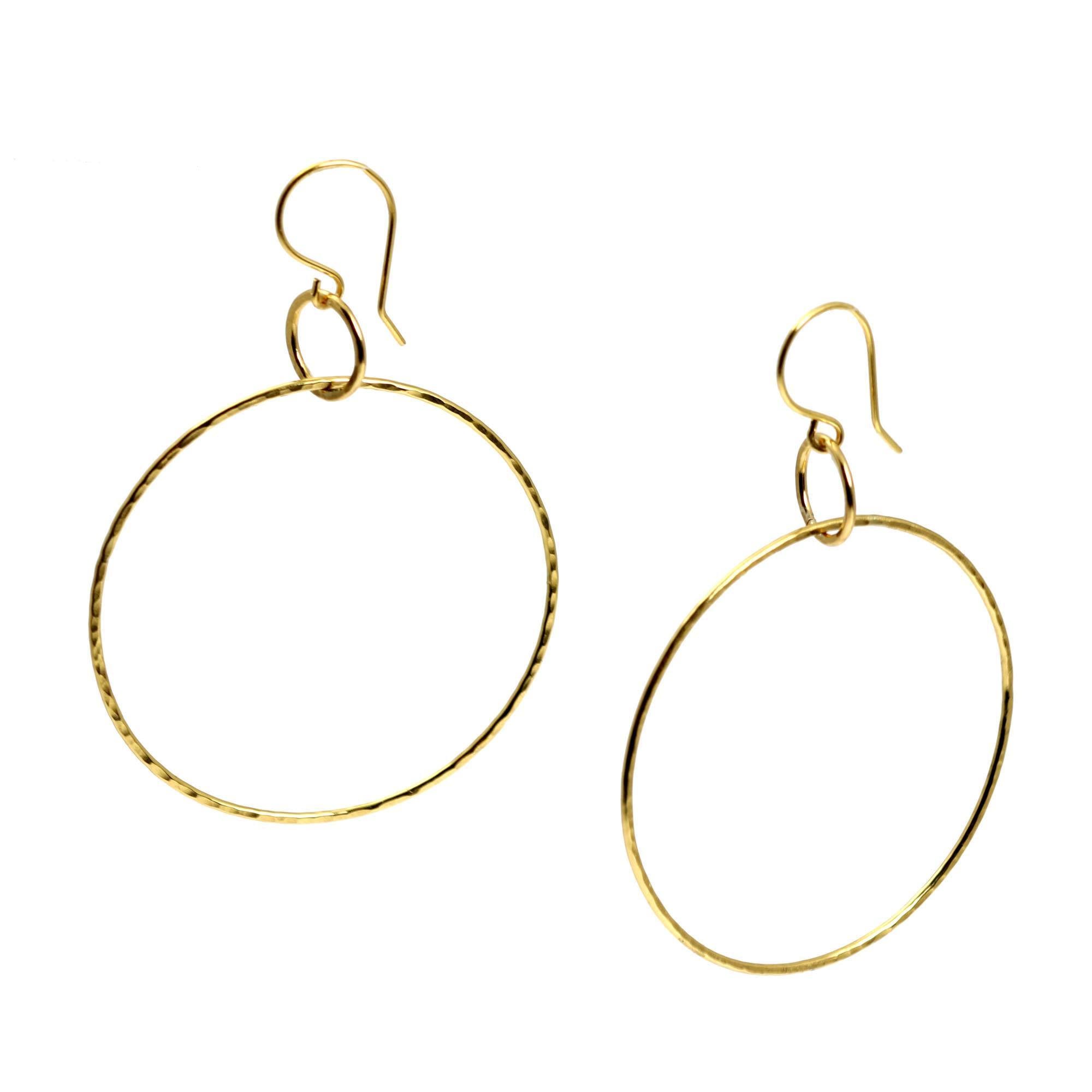 A Pair of Hammered Nu Gold Brass Hoop Earrings on a White Background