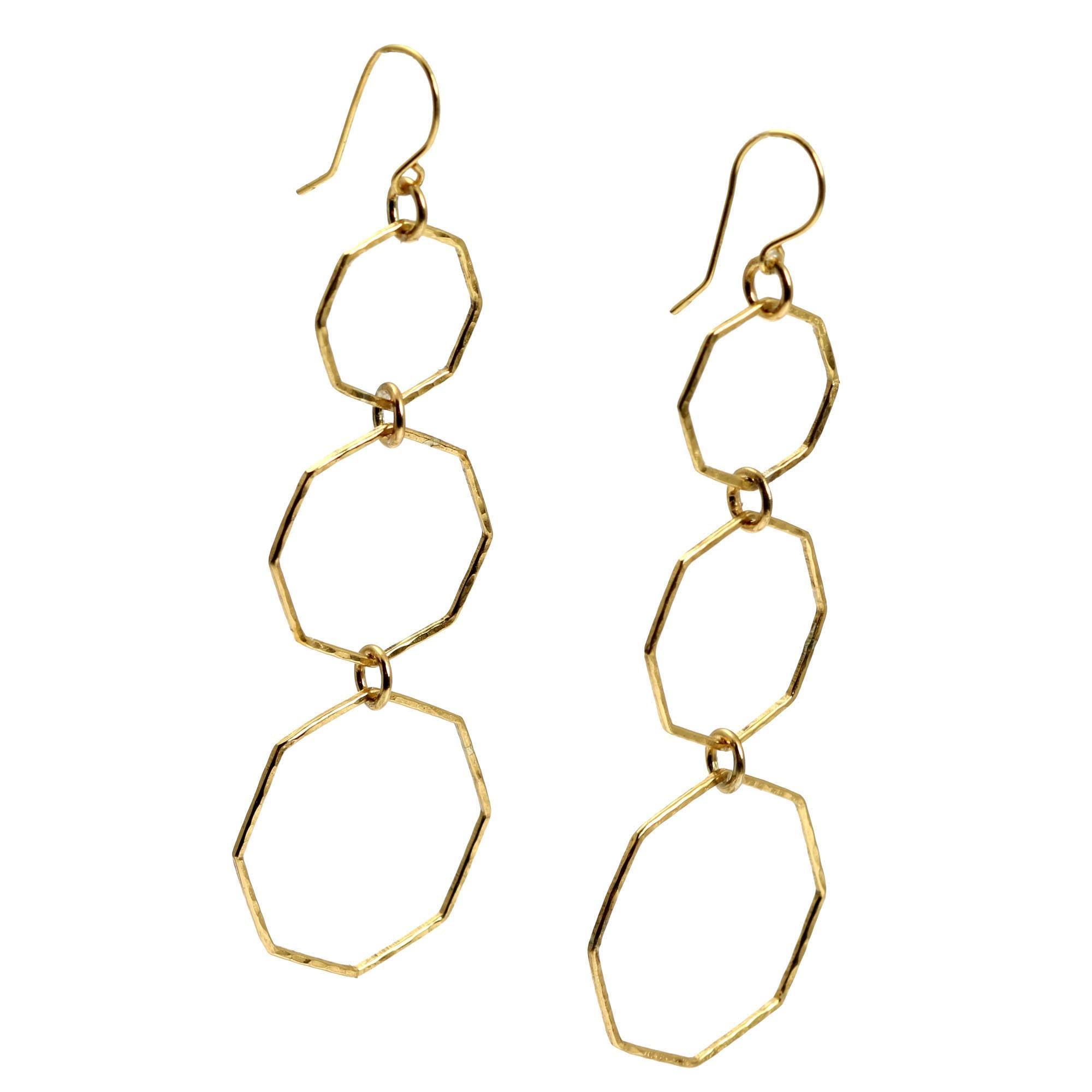 A Pair of Hammered Nu Gold Brass Octagon Dangle Earrings on a White Background