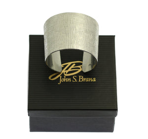6 of 6: Linen Texturized Aluminum Cuff on Top of a Black Branded Gift Box