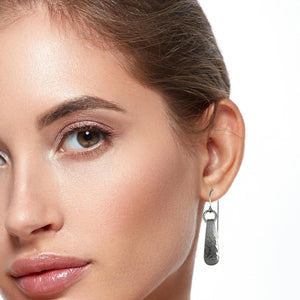 2 of 5: Mini Hammered Stainless Steel Drop Earrings on Female Model